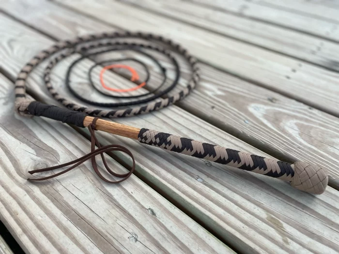 Brown and tan stock whip with plaited handle