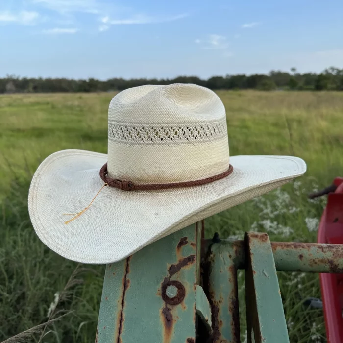 Walnut brown miniature whip hatband on a straw cowboy hat